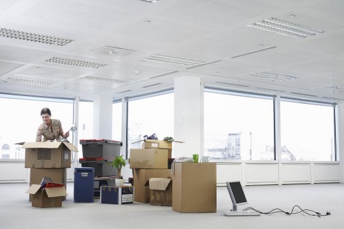 Removalists carrying boxes through a Central London property entrance